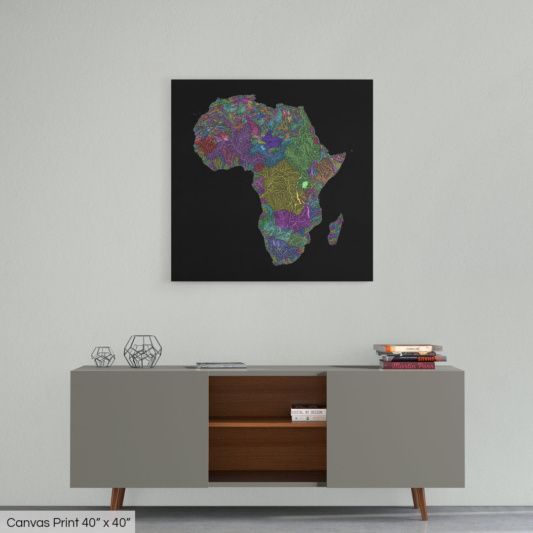 A colourful Grasshopper Geography map home decor in a living room, on a light grey wall. The map is printed on canvas and hangs above a modern low storage cabinet.