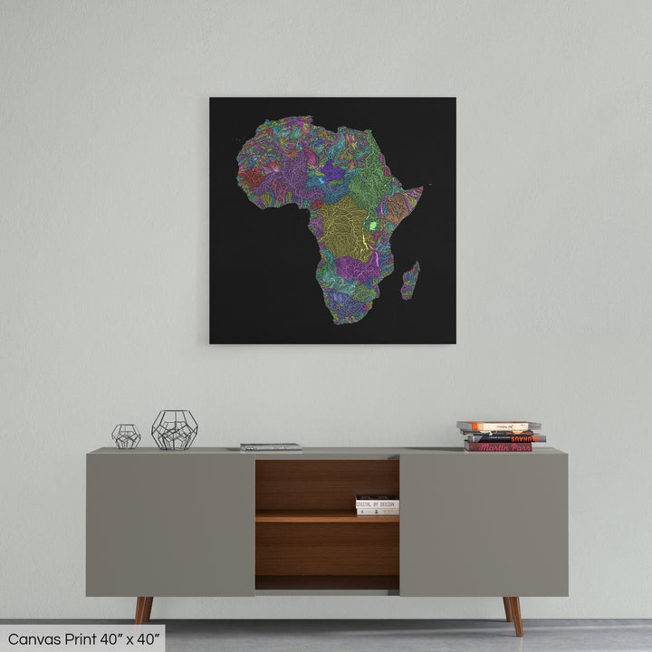 A colourful Grasshopper Geography map home decor in a living room, on a light grey wall. The map is printed on canvas and hangs above a modern low storage cabinet.