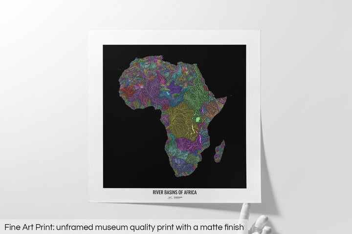 Unframed fine art print of a colourful map with a thick white mat. The title of the map and the Grasshopper Geography logo is printed on the mat, below the image. The map print lies flat on a white surface, a hand holding up one of the corners. The bottom text reads: Fine art print - unframed museum quality print with a matte finish.
