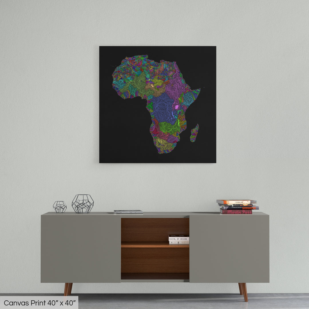 A colourful Grasshopper Geography map home decor in a living room, on a light grey wall. The map is printed on canvas and hangs above a modern low storage cabinet.