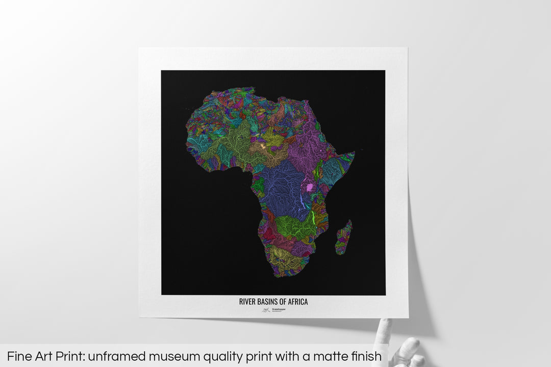 Unframed fine art print of a colourful map with a thick white mat. The title of the map and the Grasshopper Geography logo is printed on the mat, below the image. The map print lies flat on a white surface, a hand holding up one of the corners. The bottom text reads: Fine art print - unframed museum quality print with a matte finish.