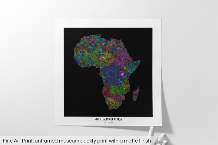 Unframed fine art print of a colourful map with a thick white mat. The title of the map and the Grasshopper Geography logo is printed on the mat, below the image. The map print lies flat on a white surface, a hand holding up one of the corners. The bottom text reads: Fine art print - unframed museum quality print with a matte finish.