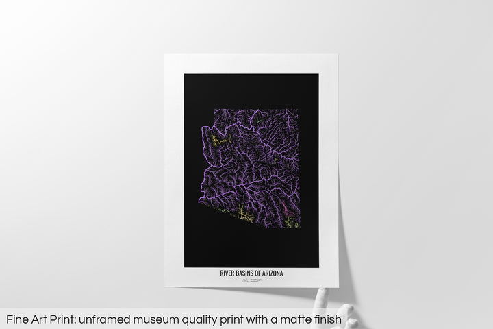 Unframed fine art print of a colourful map with a thick white mat. The title of the map and the Grasshopper Geography logo is printed on the mat, below the image. The map print lies flat on a white surface, a hand holding up one of the corners. The bottom text reads: Fine art print - unframed museum quality print with a matte finish.