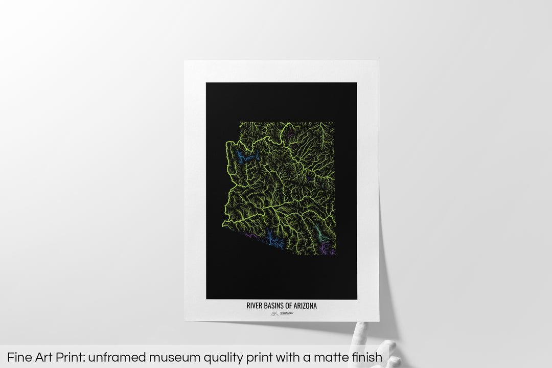 Unframed fine art print of a colourful map with a thick white mat. The title of the map and the Grasshopper Geography logo is printed on the mat, below the image. The map print lies flat on a white surface, a hand holding up one of the corners. The bottom text reads: Fine art print - unframed museum quality print with a matte finish.