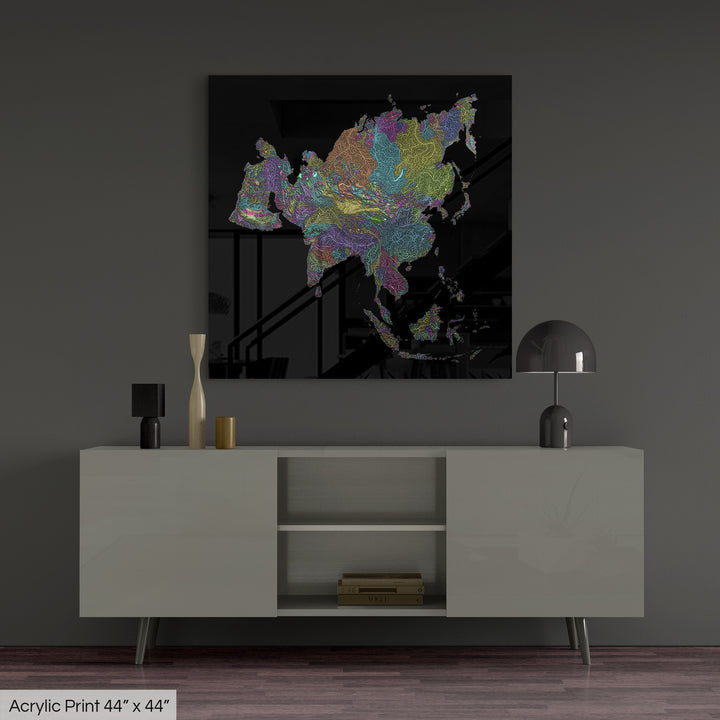 A colourful Grasshopper Geography map, home decor hanging on a grey wall in a living room. The map is printed on an acrylic panel and hangs above a modern low storage cabinet.