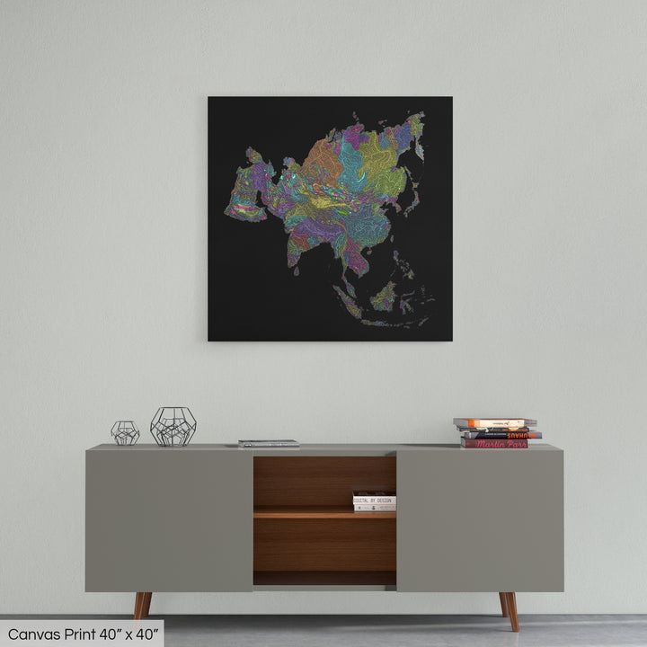A colourful Grasshopper Geography map home decor in a living room, on a light grey wall. The map is printed on canvas and hangs above a modern low storage cabinet.