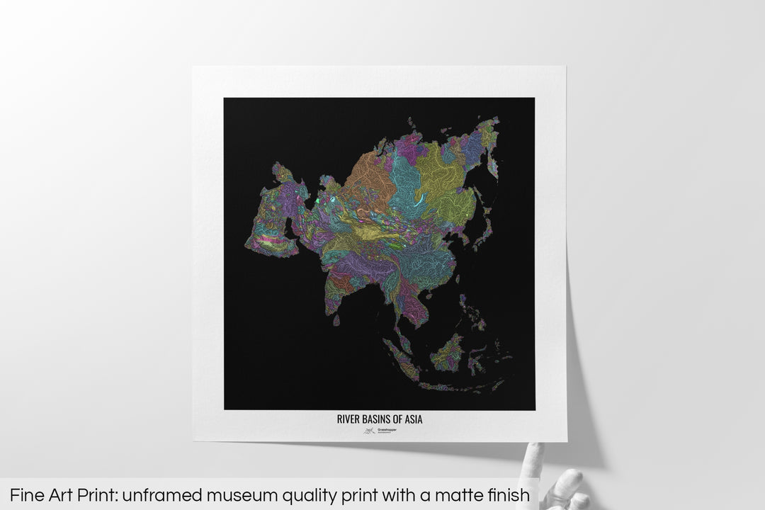 Unframed fine art print of a colourful map with a thick white mat. The title of the map and the Grasshopper Geography logo is printed on the mat, below the image. The map print lies flat on a white surface, a hand holding up one of the corners. The bottom text reads: Fine art print - unframed museum quality print with a matte finish.