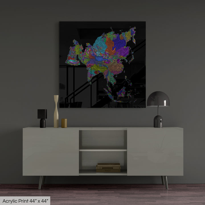 A colourful Grasshopper Geography map, home decor hanging on a grey wall in a living room. The map is printed on an acrylic panel and hangs above a modern low storage cabinet.
