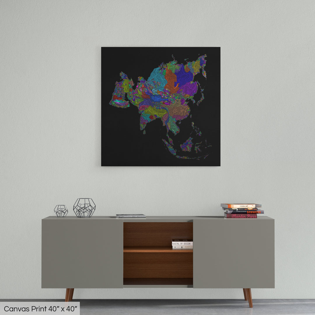 A colourful Grasshopper Geography map home decor in a living room, on a light grey wall. The map is printed on canvas and hangs above a modern low storage cabinet.