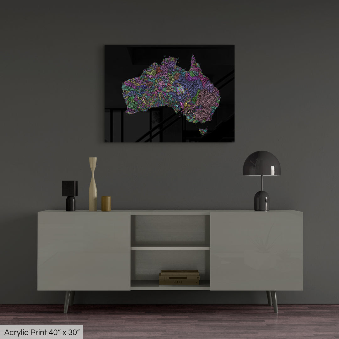 A colourful Grasshopper Geography map, home decor hanging on a grey wall in a living room. The map is printed on an acrylic panel and hangs above a modern low storage cabinet.