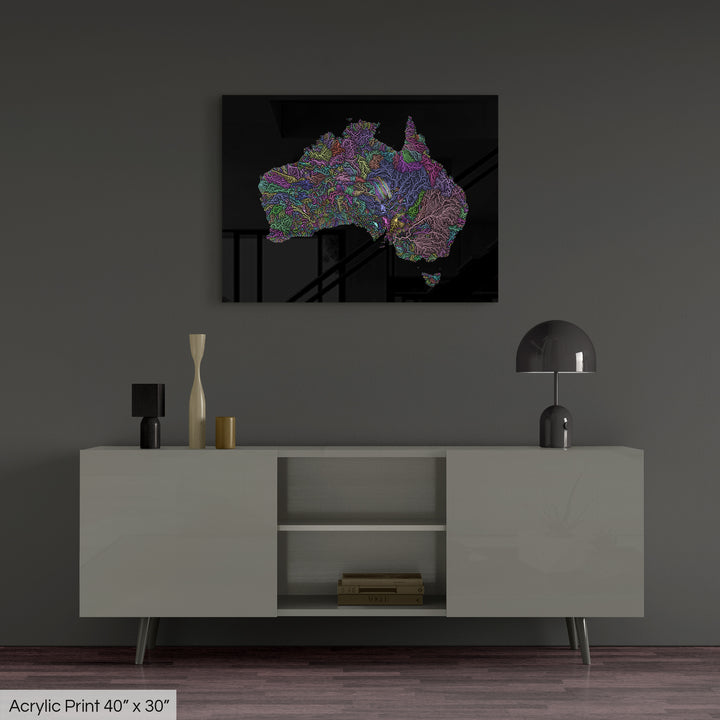 A colourful Grasshopper Geography map, home decor hanging on a grey wall in a living room. The map is printed on an acrylic panel and hangs above a modern low storage cabinet.