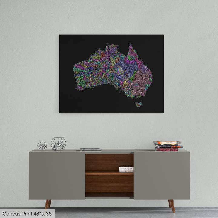 A colourful Grasshopper Geography map home decor in a living room, on a light grey wall. The map is printed on canvas and hangs above a modern low storage cabinet.
