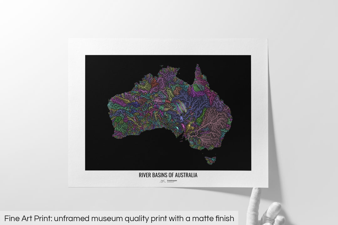 Unframed fine art print of a colourful map with a thick white mat. The title of the map and the Grasshopper Geography logo is printed on the mat, below the image. The map print lies flat on a white surface, a hand holding up one of the corners. The bottom text reads: Fine art print - unframed museum quality print with a matte finish.