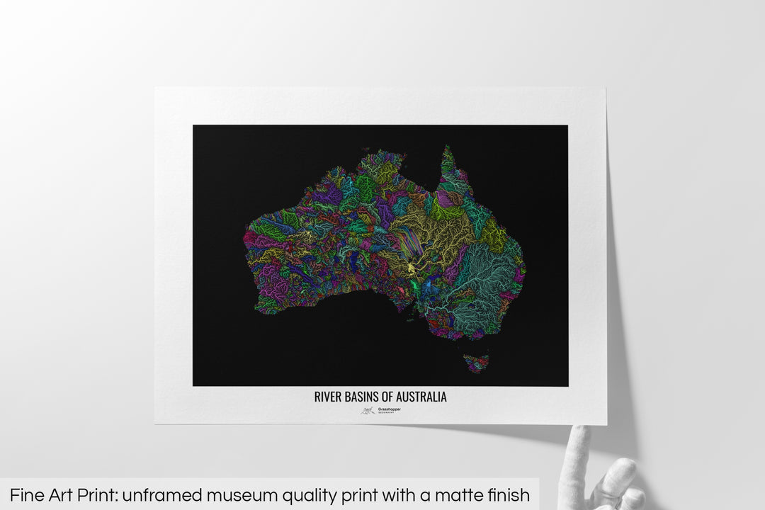 Unframed fine art print of a colourful map with a thick white mat. The title of the map and the Grasshopper Geography logo is printed on the mat, below the image. The map print lies flat on a white surface, a hand holding up one of the corners. The bottom text reads: Fine art print - unframed museum quality print with a matte finish.