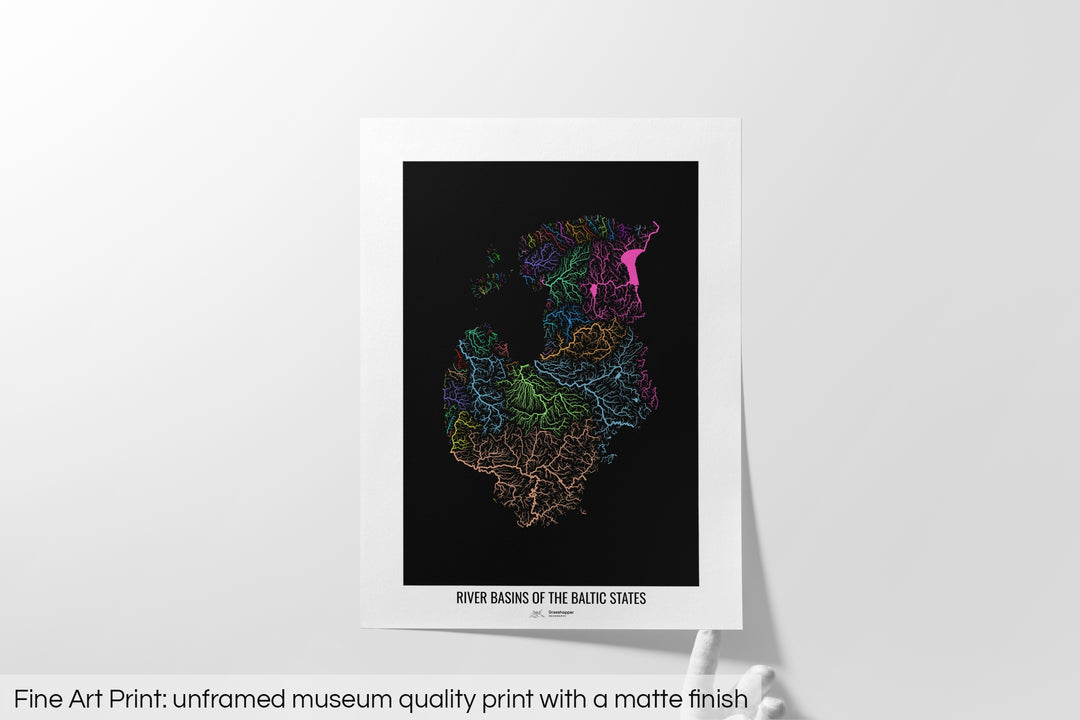Unframed fine art print of a colourful map with a thick white mat. The title of the map and the Grasshopper Geography logo is printed on the mat, below the image. The map print lies flat on a white surface, a hand holding up one of the corners. The bottom text reads: Fine art print - unframed museum quality print with a matte finish.
