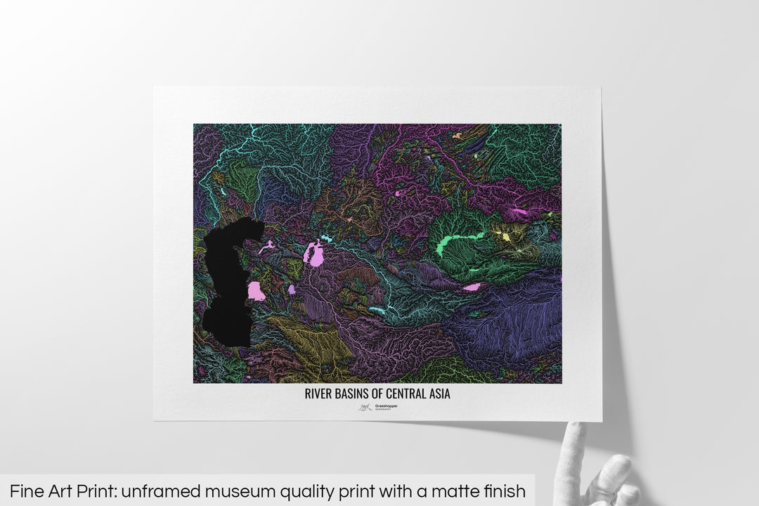 Unframed fine art print of a colourful map with a thick white mat. The title of the map and the Grasshopper Geography logo is printed on the mat, below the image. The map print lies flat on a white surface, a hand holding up one of the corners. The bottom text reads: Fine art print - unframed museum quality print with a matte finish.