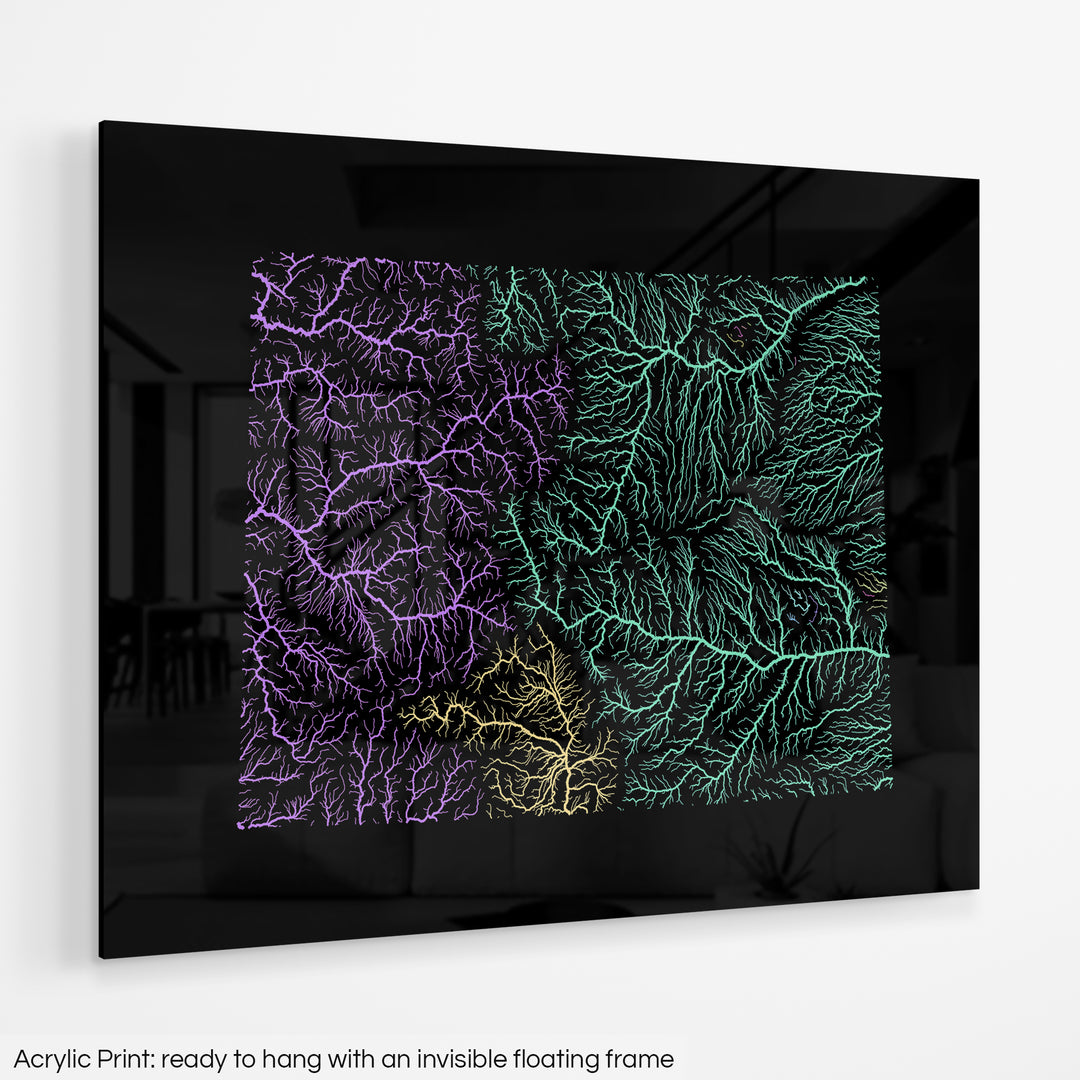 A colourful Grasshopper Geography map hanging on a white wall. The text at the bottom reads: Acrylic print - ready to hang with an invisible floating frame.