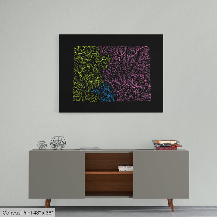 A colourful Grasshopper Geography map home decor in a living room, on a light grey wall. The map is printed on canvas and hangs above a modern low storage cabinet.