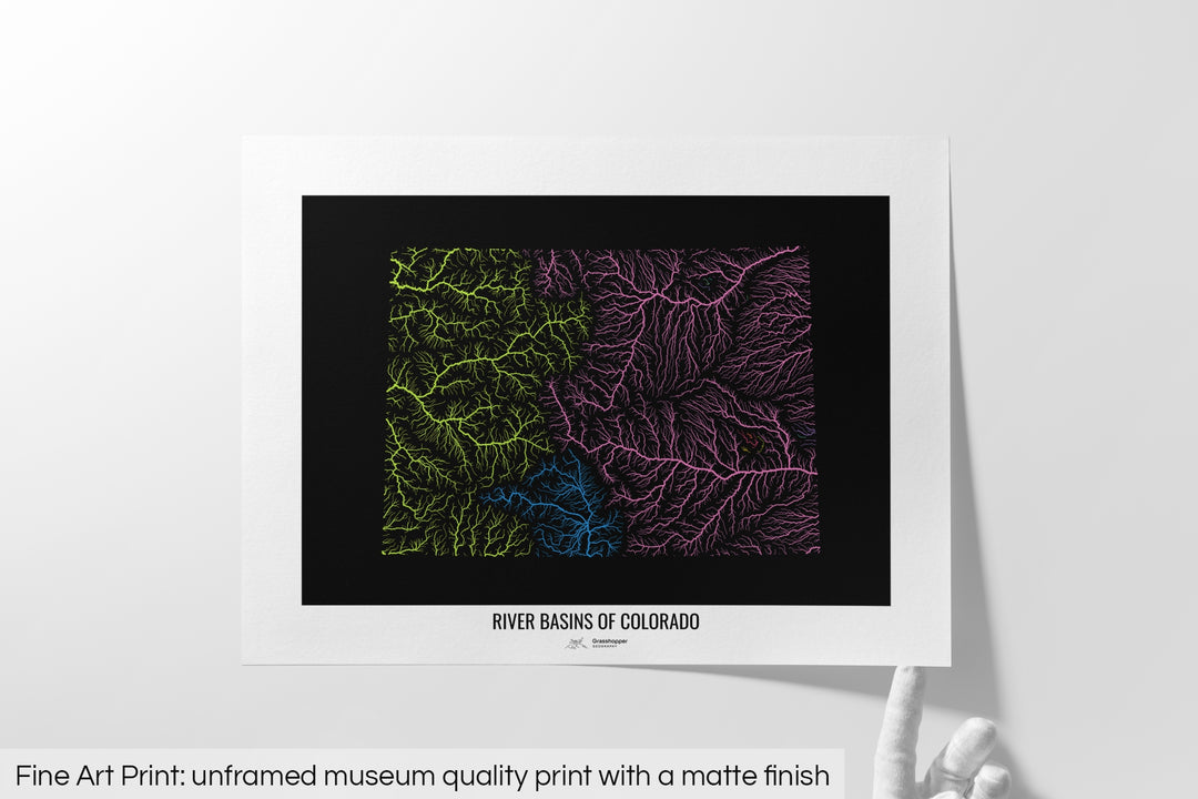 Unframed fine art print of a colourful map with a thick white mat. The title of the map and the Grasshopper Geography logo is printed on the mat, below the image. The map print lies flat on a white surface, a hand holding up one of the corners. The bottom text reads: Fine art print - unframed museum quality print with a matte finish.