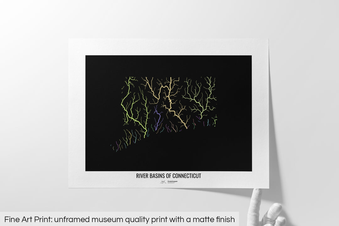 Unframed fine art print of a colourful map with a thick white mat. The title of the map and the Grasshopper Geography logo is printed on the mat, below the image. The map print lies flat on a white surface, a hand holding up one of the corners. The bottom text reads: Fine art print - unframed museum quality print with a matte finish.