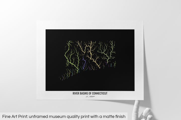 Unframed fine art print of a colourful map with a thick white mat. The title of the map and the Grasshopper Geography logo is printed on the mat, below the image. The map print lies flat on a white surface, a hand holding up one of the corners. The bottom text reads: Fine art print - unframed museum quality print with a matte finish.