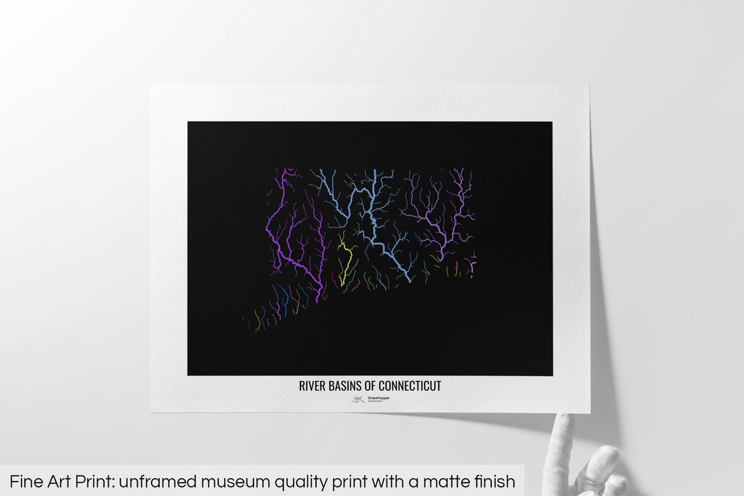 Unframed fine art print of a colourful map with a thick white mat. The title of the map and the Grasshopper Geography logo is printed on the mat, below the image. The map print lies flat on a white surface, a hand holding up one of the corners. The bottom text reads: Fine art print - unframed museum quality print with a matte finish.