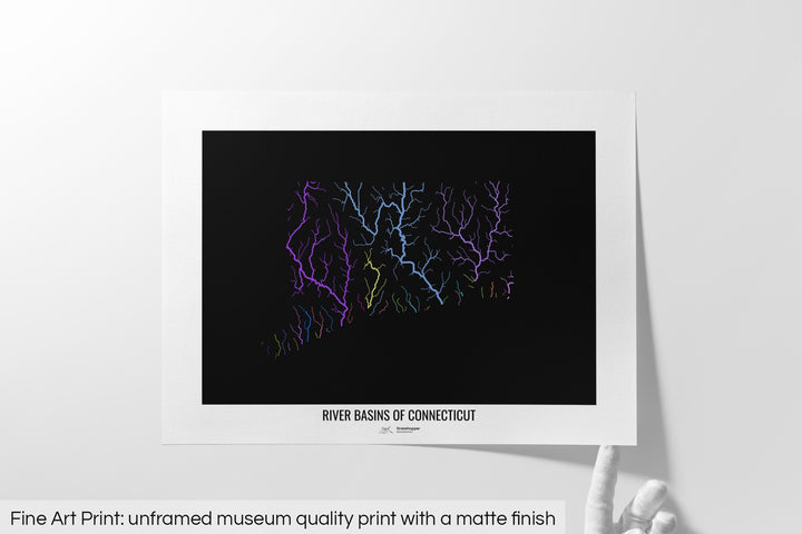 Unframed fine art print of a colourful map with a thick white mat. The title of the map and the Grasshopper Geography logo is printed on the mat, below the image. The map print lies flat on a white surface, a hand holding up one of the corners. The bottom text reads: Fine art print - unframed museum quality print with a matte finish.