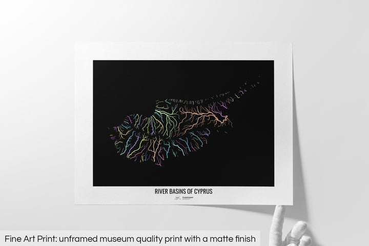 Unframed fine art print of a colourful map with a thick white mat. The title of the map and the Grasshopper Geography logo is printed on the mat, below the image. The map print lies flat on a white surface, a hand holding up one of the corners. The bottom text reads: Fine art print - unframed museum quality print with a matte finish.