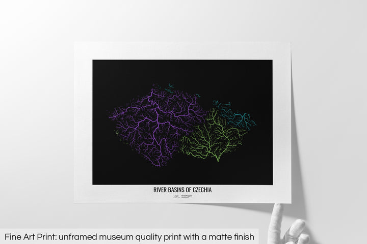 Unframed fine art print of a colourful map with a thick white mat. The title of the map and the Grasshopper Geography logo is printed on the mat, below the image. The map print lies flat on a white surface, a hand holding up one of the corners. The bottom text reads: Fine art print - unframed museum quality print with a matte finish.