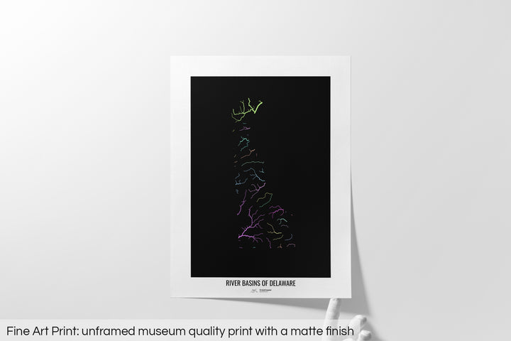 Unframed fine art print of a colourful map with a thick white mat. The title of the map and the Grasshopper Geography logo is printed on the mat, below the image. The map print lies flat on a white surface, a hand holding up one of the corners. The bottom text reads: Fine art print - unframed museum quality print with a matte finish.