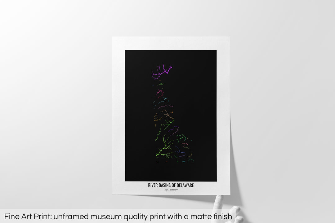 Unframed fine art print of a colourful map with a thick white mat. The title of the map and the Grasshopper Geography logo is printed on the mat, below the image. The map print lies flat on a white surface, a hand holding up one of the corners. The bottom text reads: Fine art print - unframed museum quality print with a matte finish.