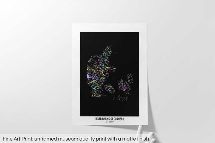 Unframed fine art print of a colourful map with a thick white mat. The title of the map and the Grasshopper Geography logo is printed on the mat, below the image. The map print lies flat on a white surface, a hand holding up one of the corners. The bottom text reads: Fine art print - unframed museum quality print with a matte finish.