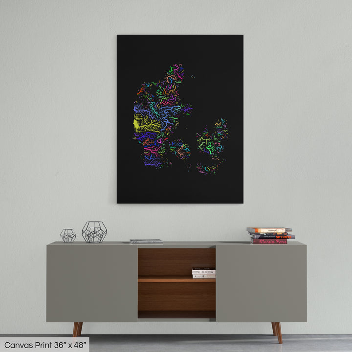 A colourful Grasshopper Geography map home decor in a living room, on a light grey wall. The map is printed on canvas and hangs above a modern low storage cabinet.