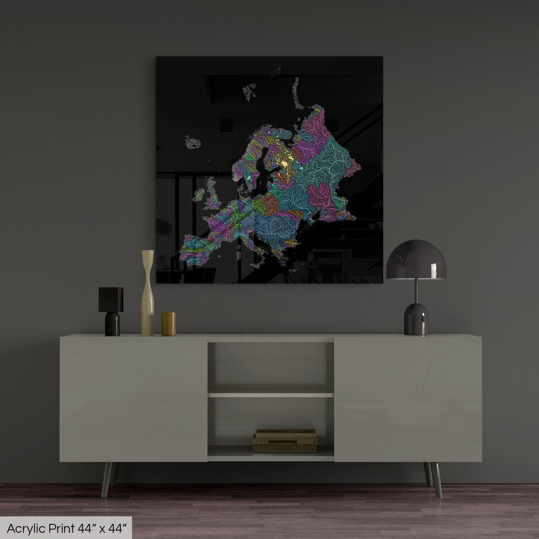 A colourful Grasshopper Geography map, home decor hanging on a grey wall in a living room. The map is printed on an acrylic panel and hangs above a modern low storage cabinet.
