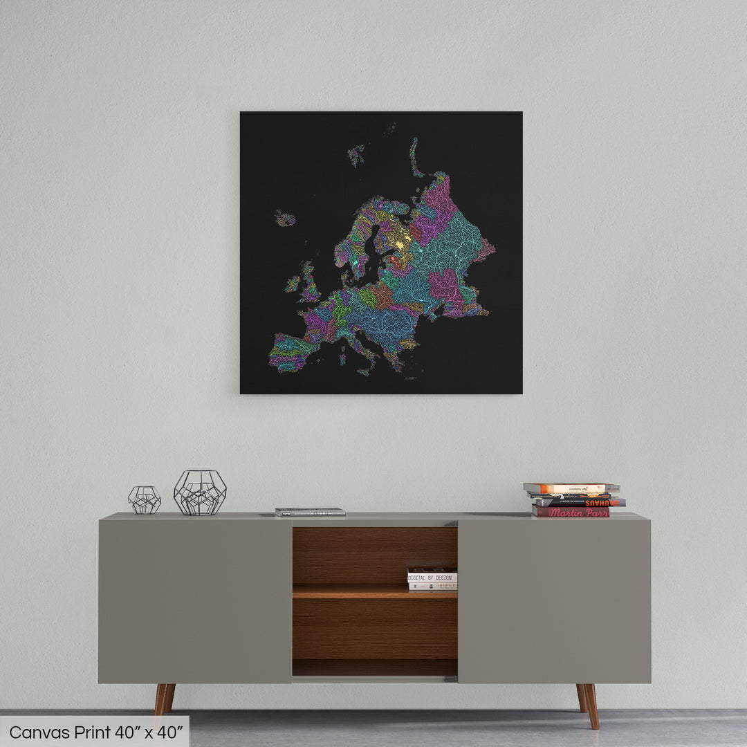 A colourful Grasshopper Geography map home decor in a living room, on a light grey wall. The map is printed on canvas and hangs above a modern low storage cabinet.