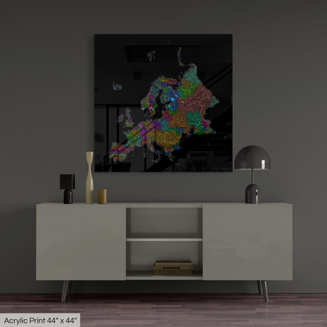 A colourful Grasshopper Geography map, home decor hanging on a grey wall in a living room. The map is printed on an acrylic panel and hangs above a modern low storage cabinet.