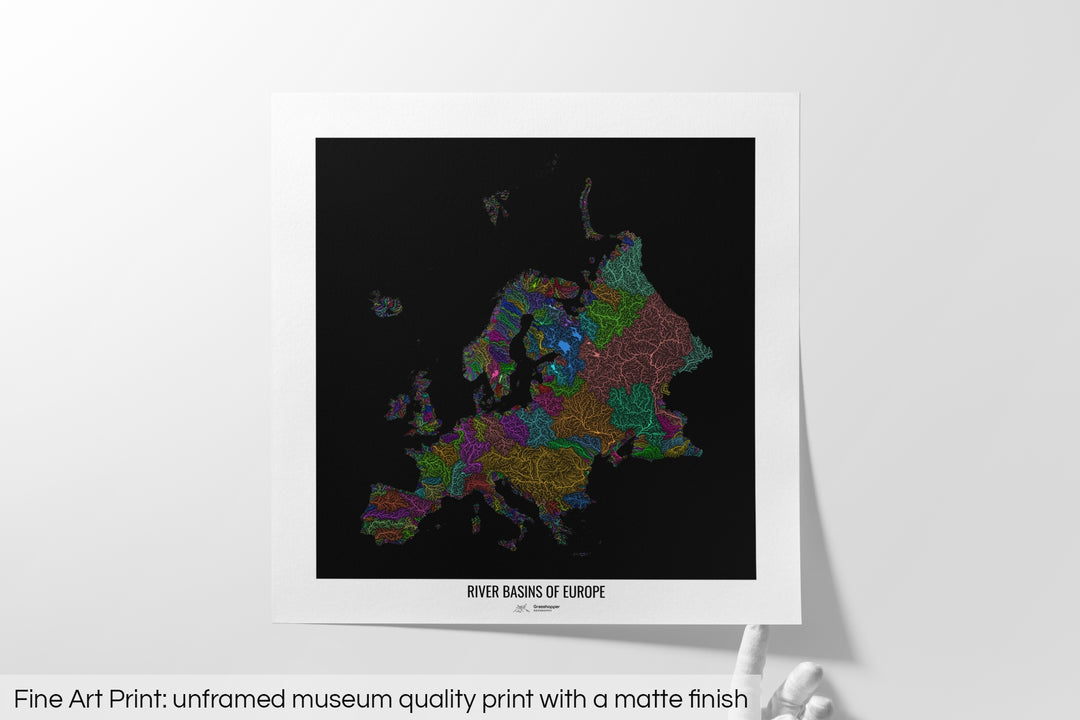 Unframed fine art print of a colourful map with a thick white mat. The title of the map and the Grasshopper Geography logo is printed on the mat, below the image. The map print lies flat on a white surface, a hand holding up one of the corners. The bottom text reads: Fine art print - unframed museum quality print with a matte finish.