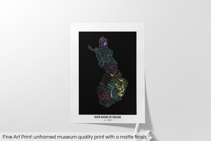 Unframed fine art print of a colourful map with a thick white mat. The title of the map and the Grasshopper Geography logo is printed on the mat, below the image. The map print lies flat on a white surface, a hand holding up one of the corners. The bottom text reads: Fine art print - unframed museum quality print with a matte finish.