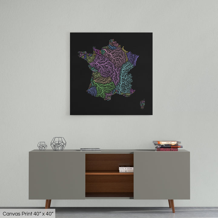 A colourful Grasshopper Geography map home decor in a living room, on a light grey wall. The map is printed on canvas and hangs above a modern low storage cabinet.