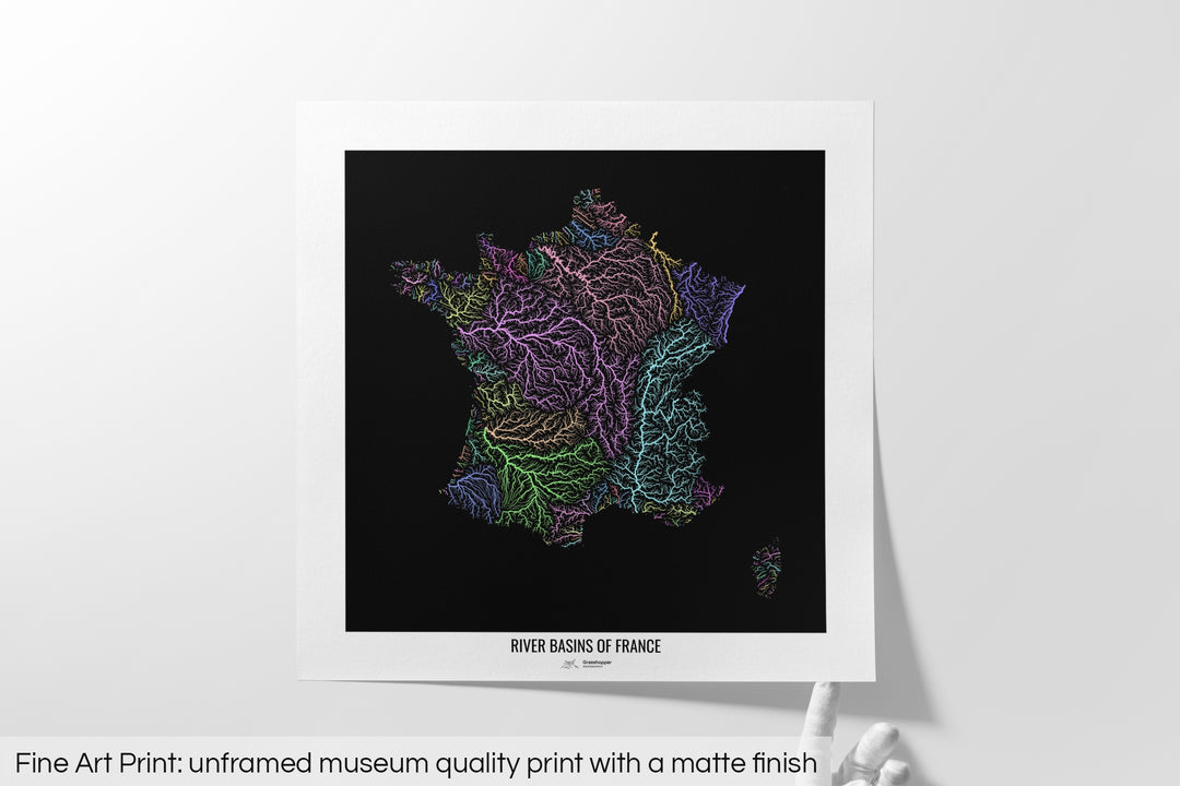 Unframed fine art print of a colourful map with a thick white mat. The title of the map and the Grasshopper Geography logo is printed on the mat, below the image. The map print lies flat on a white surface, a hand holding up one of the corners. The bottom text reads: Fine art print - unframed museum quality print with a matte finish.