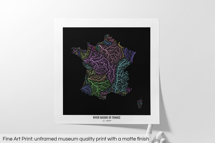 Unframed fine art print of a colourful map with a thick white mat. The title of the map and the Grasshopper Geography logo is printed on the mat, below the image. The map print lies flat on a white surface, a hand holding up one of the corners. The bottom text reads: Fine art print - unframed museum quality print with a matte finish.