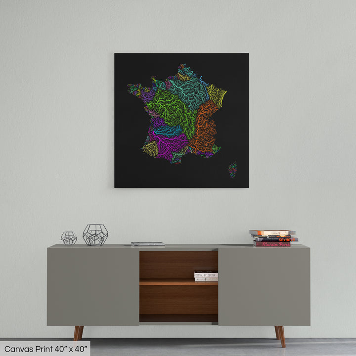 A colourful Grasshopper Geography map home decor in a living room, on a light grey wall. The map is printed on canvas and hangs above a modern low storage cabinet.