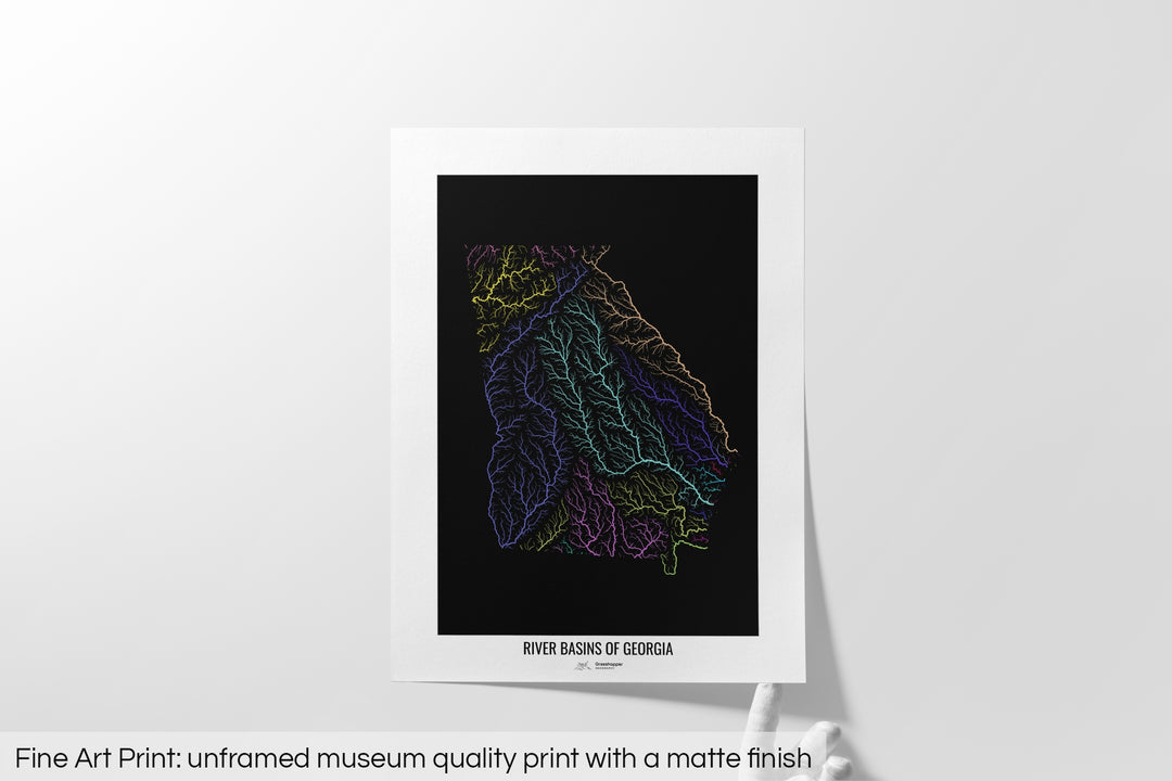 Unframed fine art print of a colourful map with a thick white mat. The title of the map and the Grasshopper Geography logo is printed on the mat, below the image. The map print lies flat on a white surface, a hand holding up one of the corners. The bottom text reads: Fine art print - unframed museum quality print with a matte finish.