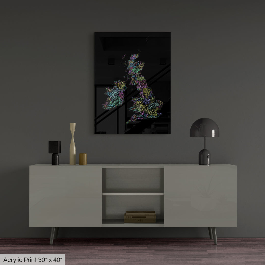 A colourful Grasshopper Geography map, home decor hanging on a grey wall in a living room. The map is printed on an acrylic panel and hangs above a modern low storage cabinet.