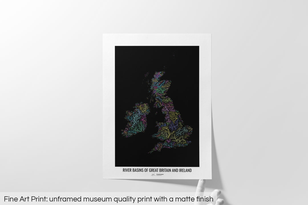 Unframed fine art print of a colourful map with a thick white mat. The title of the map and the Grasshopper Geography logo is printed on the mat, below the image. The map print lies flat on a white surface, a hand holding up one of the corners. The bottom text reads: Fine art print - unframed museum quality print with a matte finish.