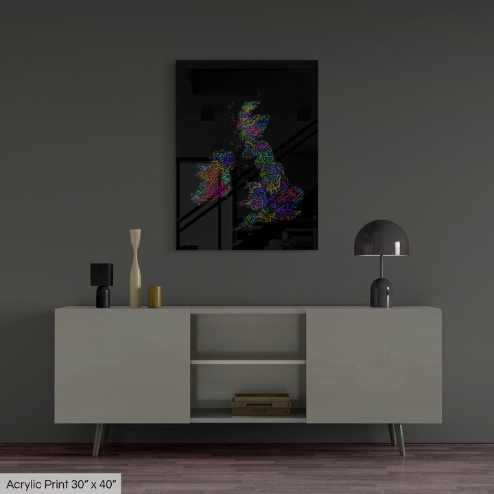 A colourful Grasshopper Geography map, home decor hanging on a grey wall in a living room. The map is printed on an acrylic panel and hangs above a modern low storage cabinet.