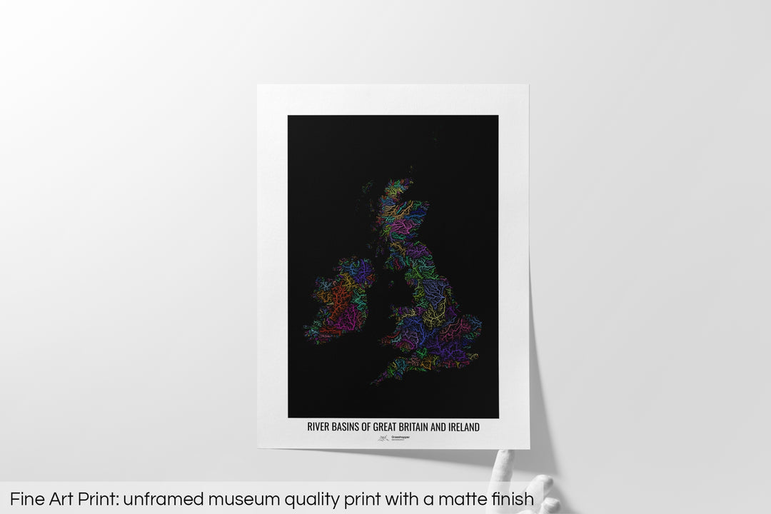 Unframed fine art print of a colourful map with a thick white mat. The title of the map and the Grasshopper Geography logo is printed on the mat, below the image. The map print lies flat on a white surface, a hand holding up one of the corners. The bottom text reads: Fine art print - unframed museum quality print with a matte finish.