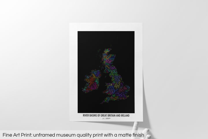 Unframed fine art print of a colourful map with a thick white mat. The title of the map and the Grasshopper Geography logo is printed on the mat, below the image. The map print lies flat on a white surface, a hand holding up one of the corners. The bottom text reads: Fine art print - unframed museum quality print with a matte finish.