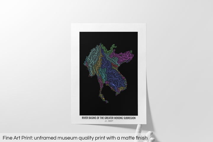 Unframed fine art print of a colourful map with a thick white mat. The title of the map and the Grasshopper Geography logo is printed on the mat, below the image. The map print lies flat on a white surface, a hand holding up one of the corners. The bottom text reads: Fine art print - unframed museum quality print with a matte finish.