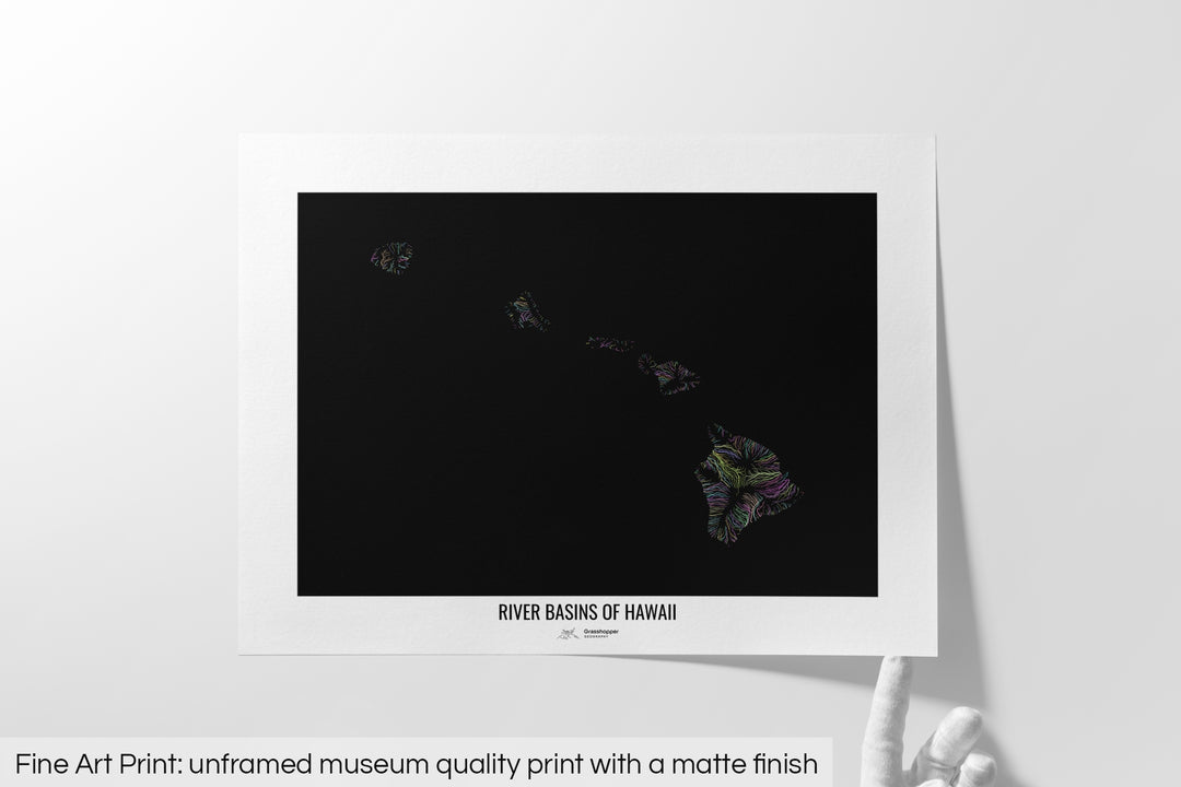 Unframed fine art print of a colourful map with a thick white mat. The title of the map and the Grasshopper Geography logo is printed on the mat, below the image. The map print lies flat on a white surface, a hand holding up one of the corners. The bottom text reads: Fine art print - unframed museum quality print with a matte finish.